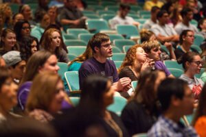 ĵֱ students listen to speaker in auditorium