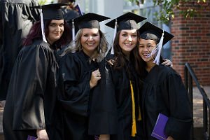 ĵֱ students in cap and gown standing in line at graduation